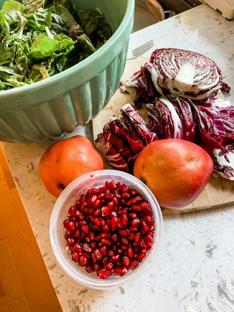 Some of the toppings and ingredients for the Chicory, Pear and Pomegranate Salad with Cranberry Vinaigrette