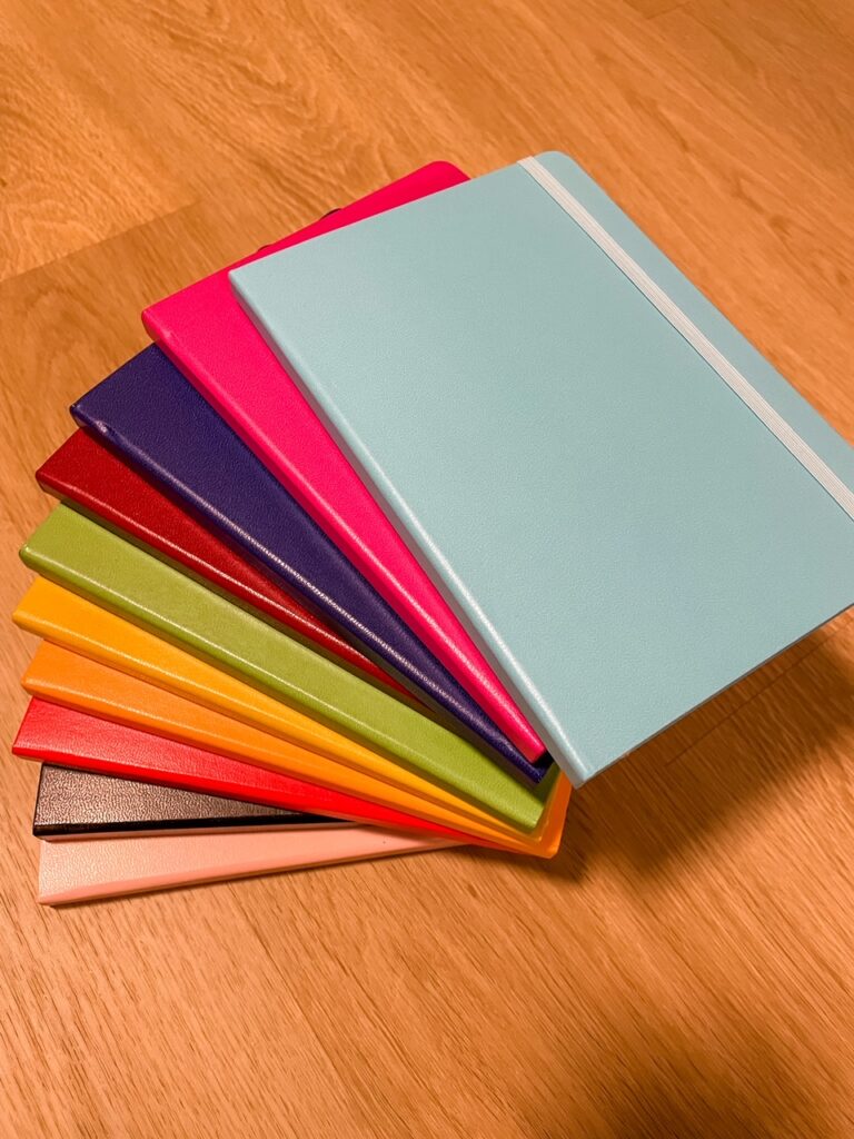 A pile of multicolored notebooks