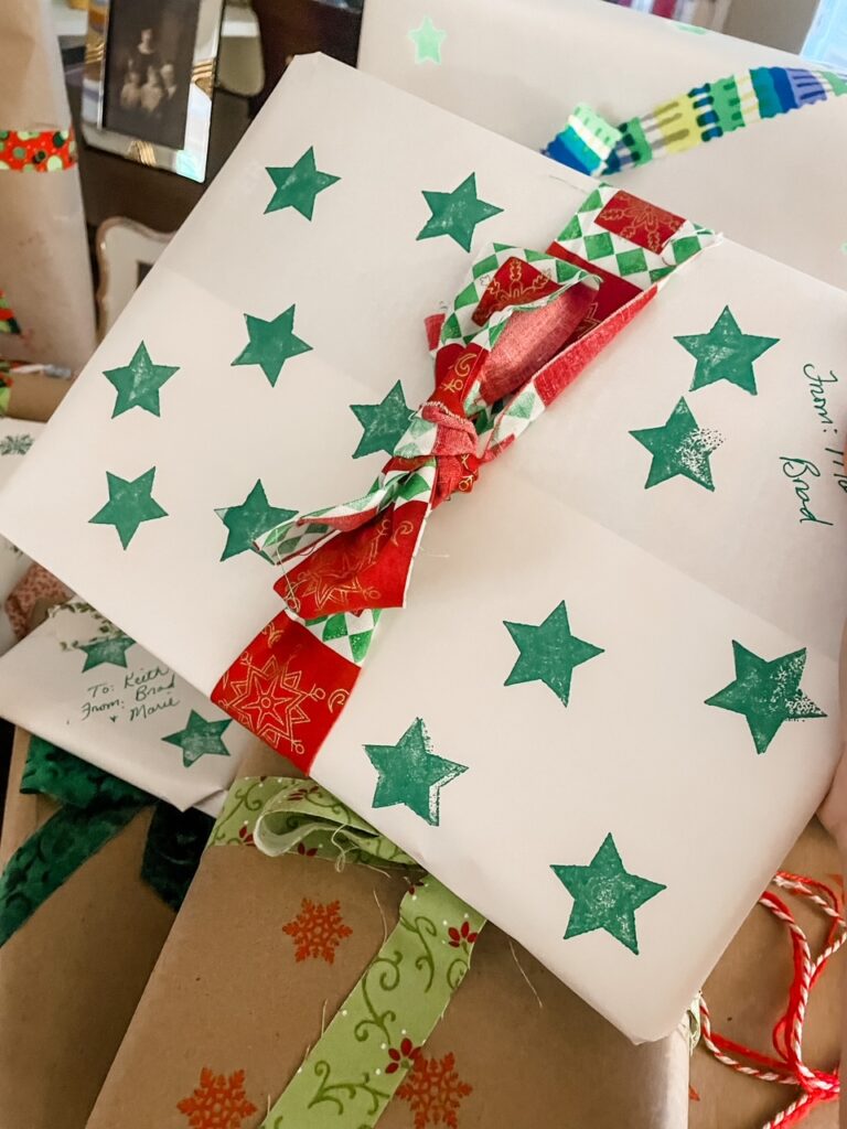 A finished present wrapped in the Homemade Sustainable Gift Wrap and topped with a bow