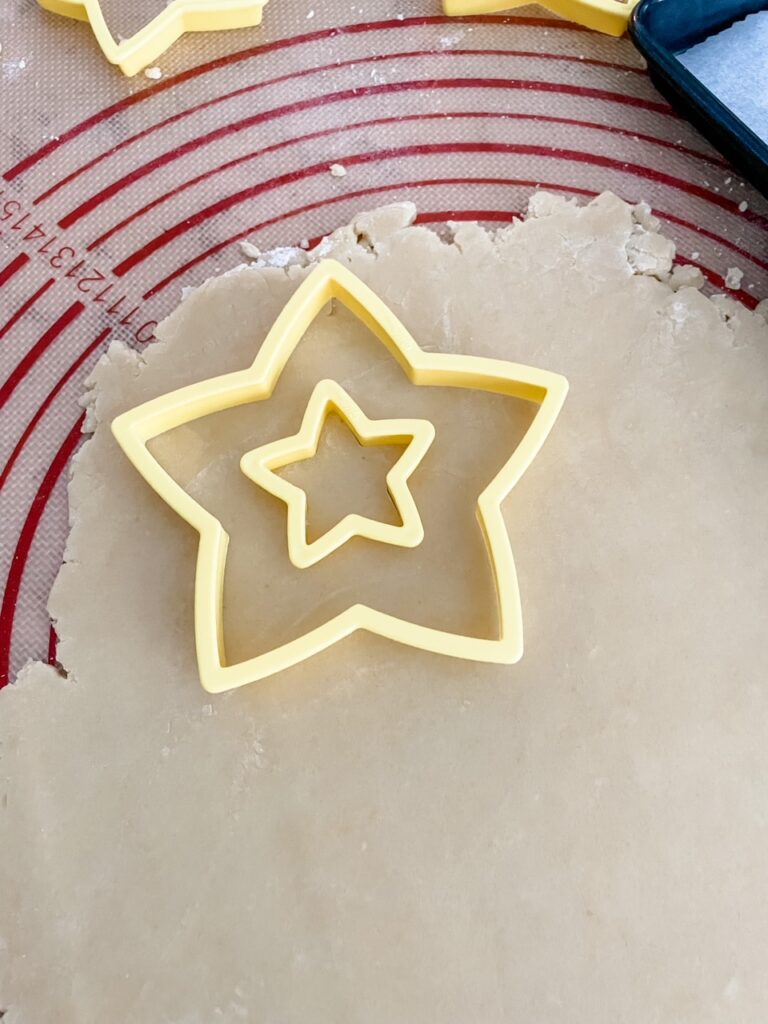 The placement of the two star cookie cutters on the dough