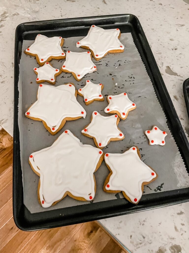 The frosted sugar cookies hardening on the tray