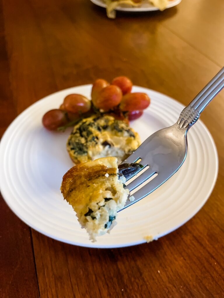 A fork holding up a piece of the Make Ahead Mediterranean Egg Cups