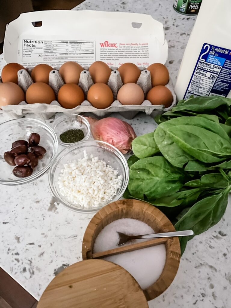 The ingredients for the Make Ahead Mediterranean Egg Cups set out on a counter top
