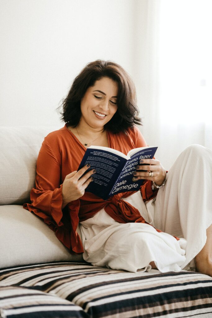 A woman reclining and reading a book