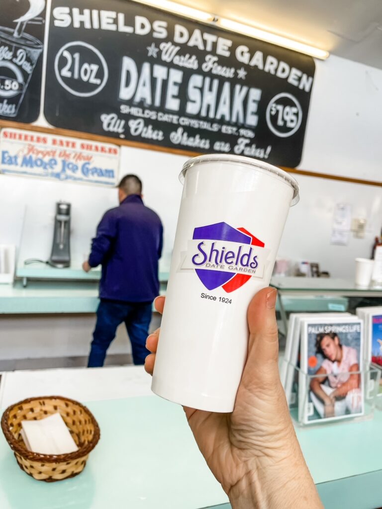 Marie holding up the Date Shake from Shields