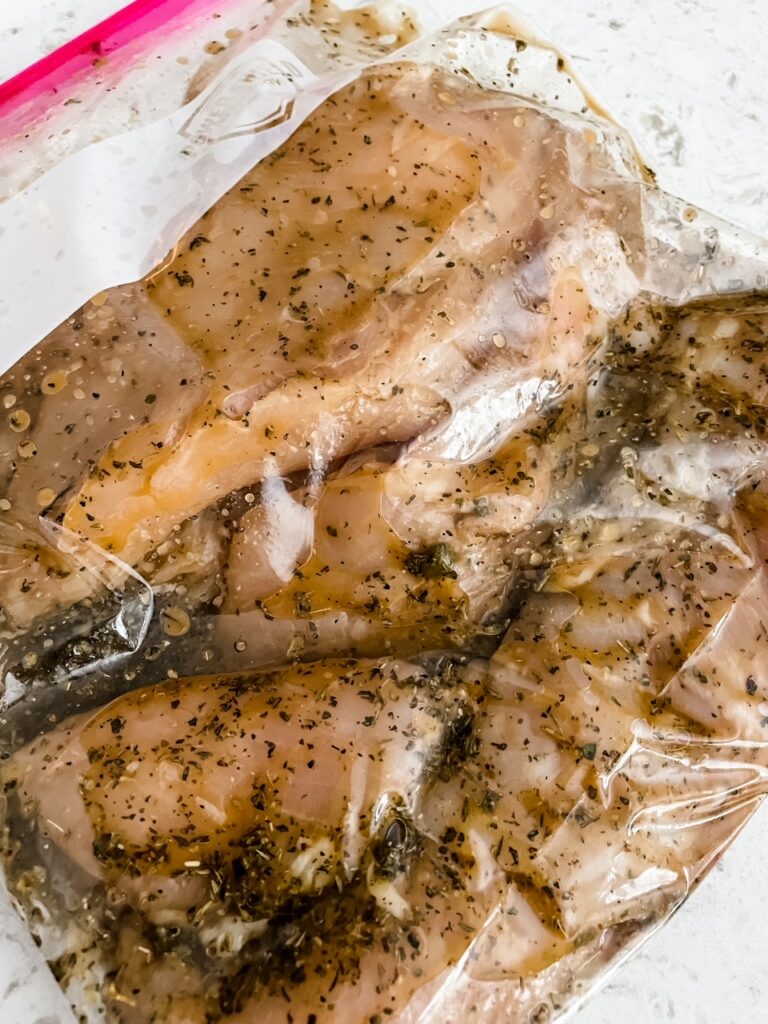 The whole chicken breast marinating