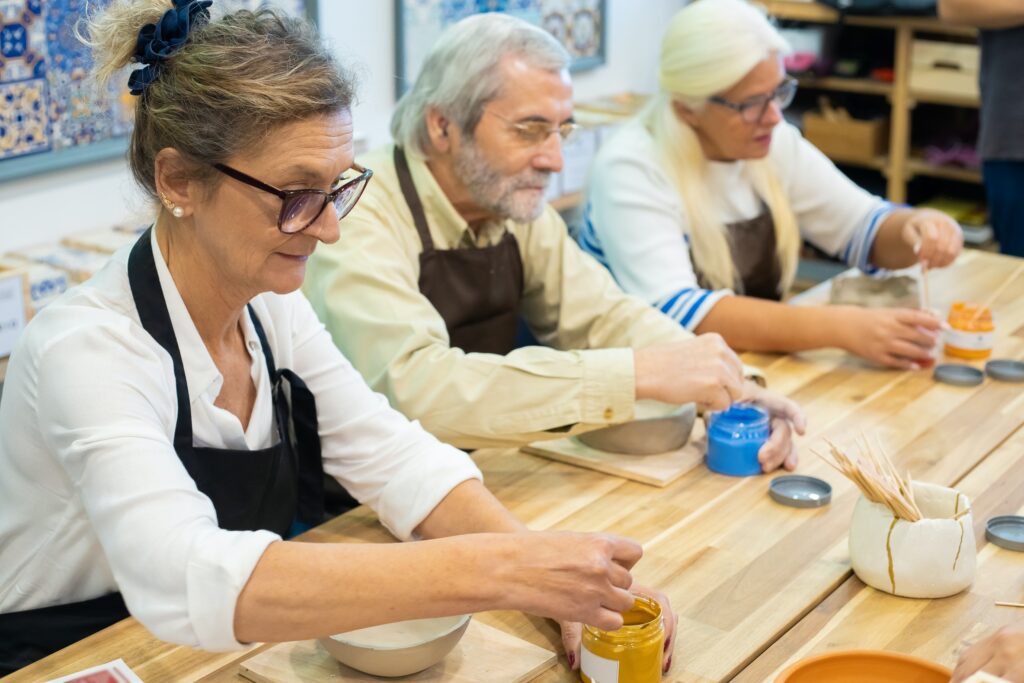 A woman painting a ceramic bowl, picking up a hobby as a method of handling aging