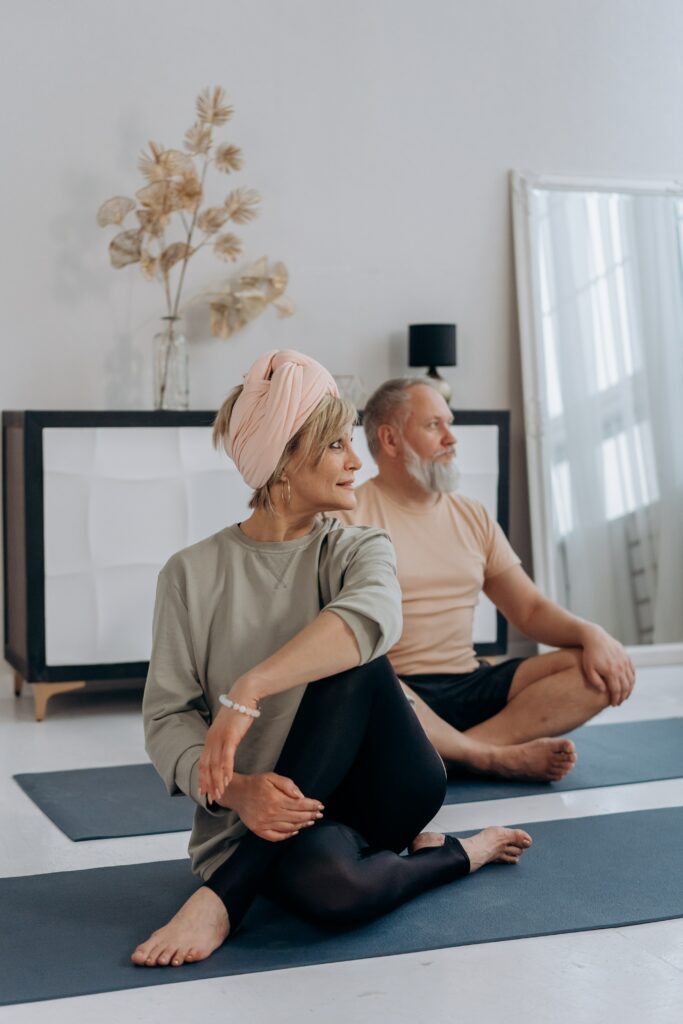 A woman and man doing a yoga stretch