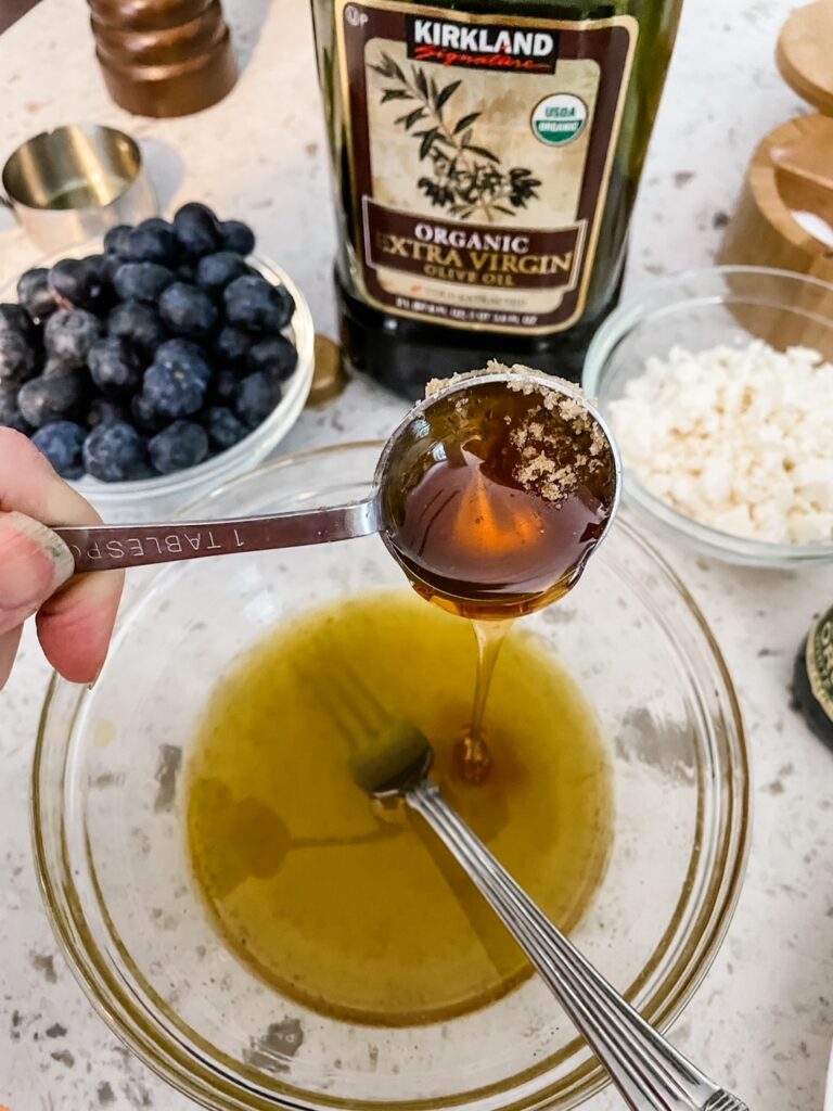 The ingredients being mixed together in a small bowl for the dressing