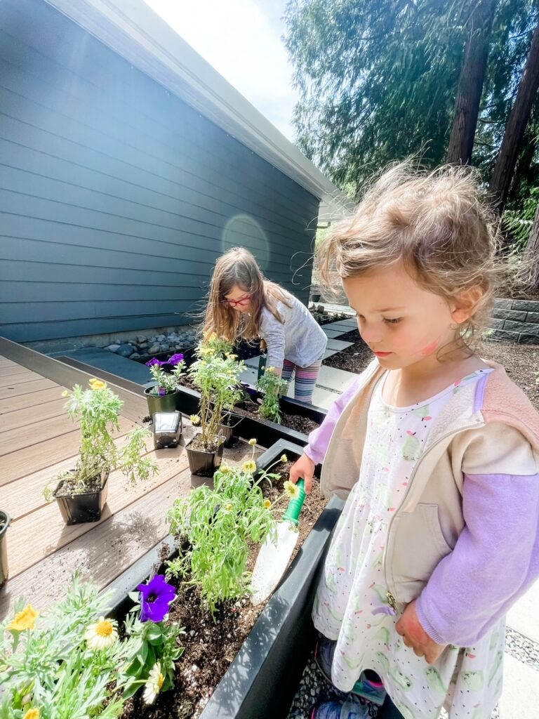 Two of Marie's grandkids helping in her garden