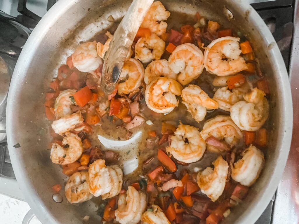 The shrimps being tossed in the sauce