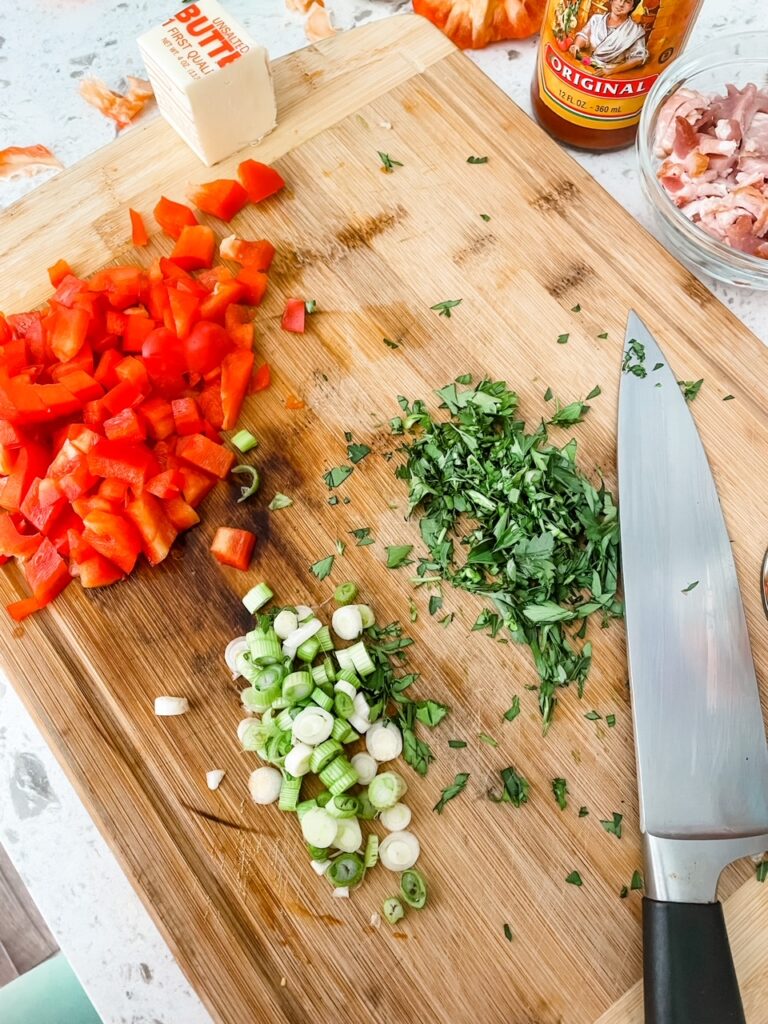Chopped vegetables and herbs on a cutting board