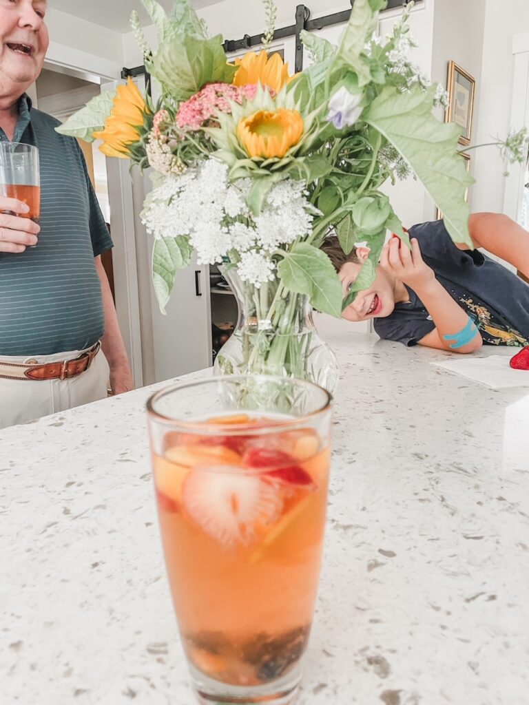 A glass of the Easy White Fruit Sangria on a countertop