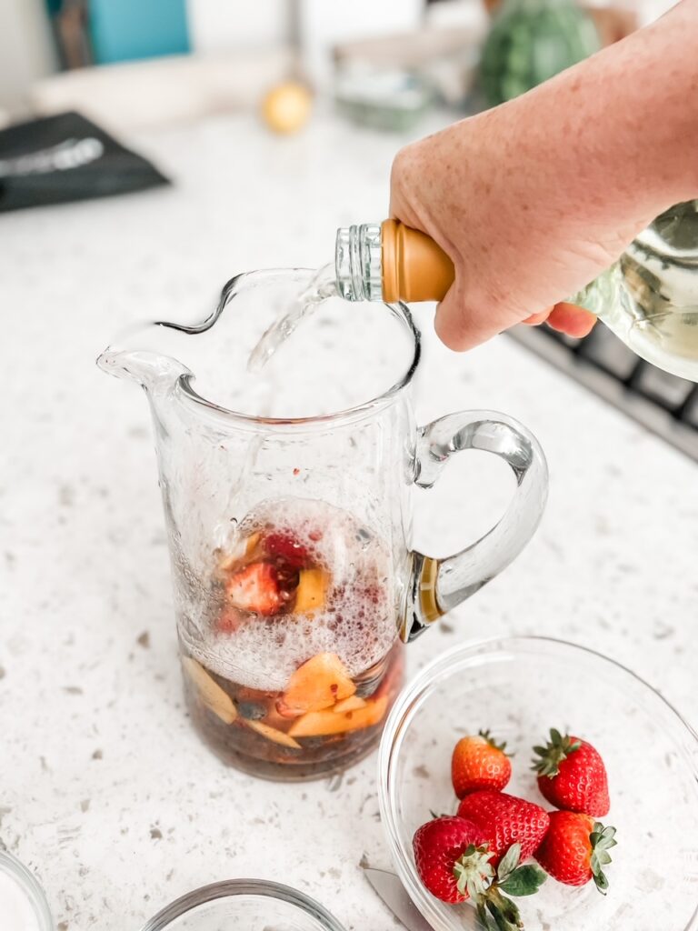 The triple sec being poured into the fruit