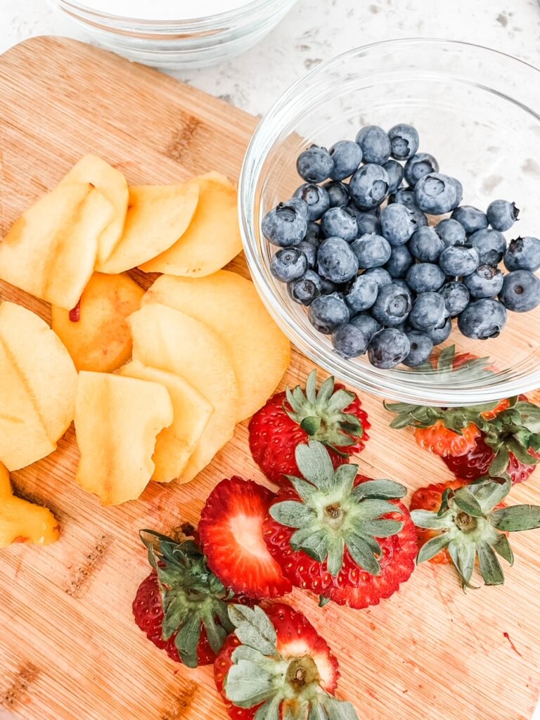 A selection of chopped blueberries, strawberries, and oranges