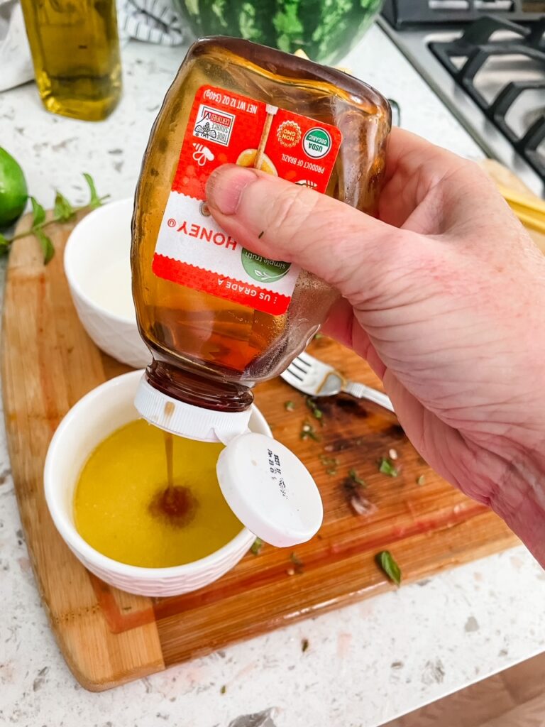 The honey being poured into the oil