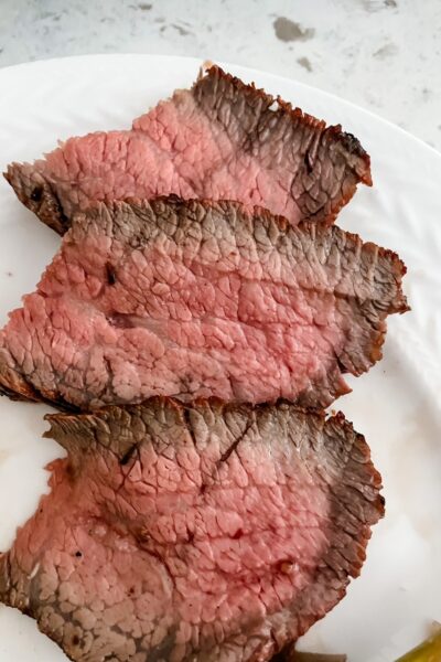 The finished and sliced marinated tri tip steak
