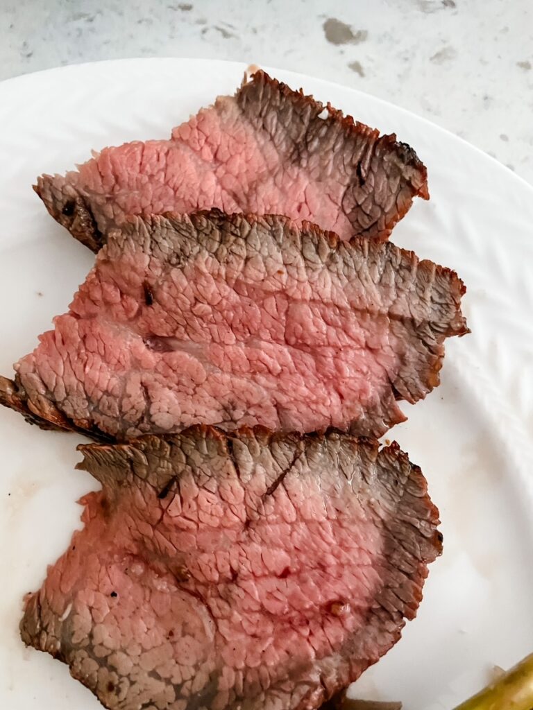 The finished and sliced marinated tri tip steak
