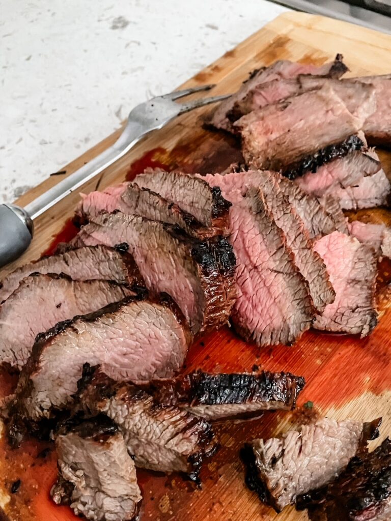 The finished and sliced marinated tri tip steak