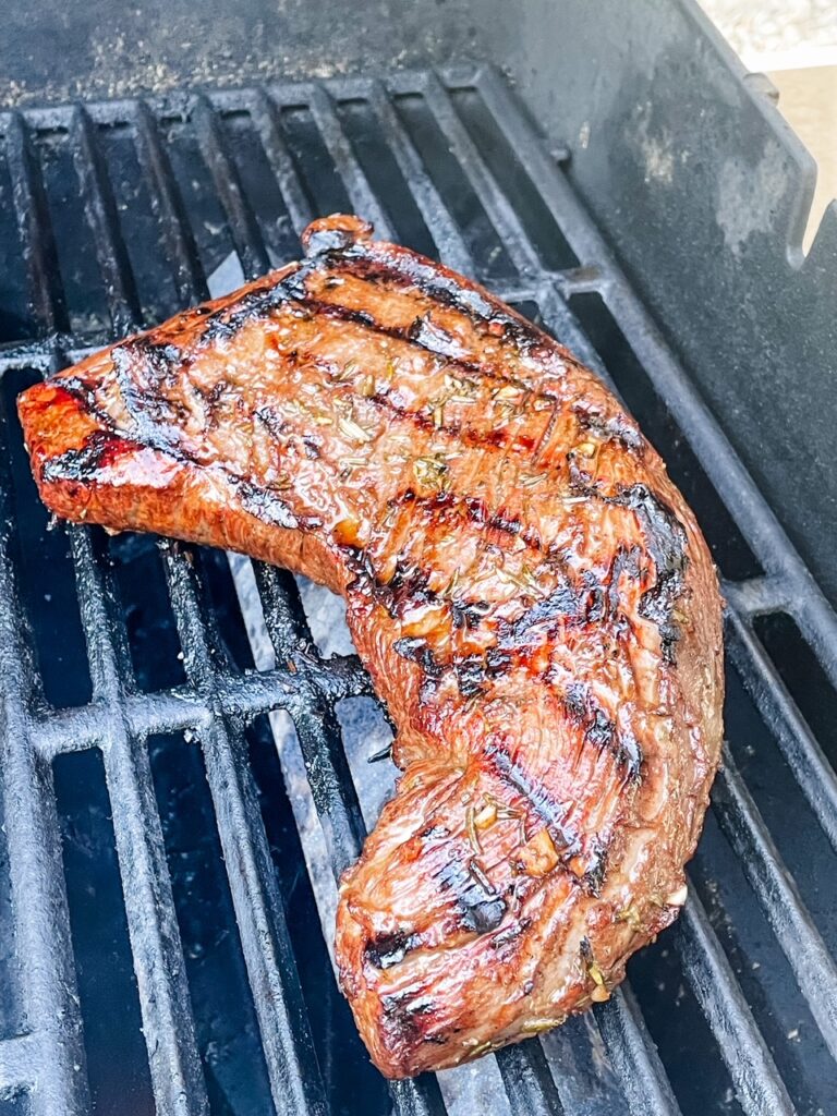 The marinated trip steak on the grill
