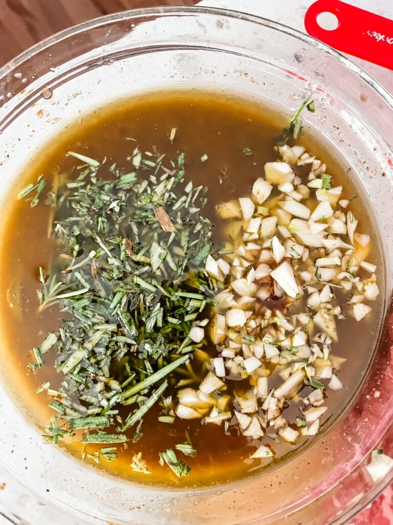 The olive oil, rosemary, vinegar, and garliic in a bowl