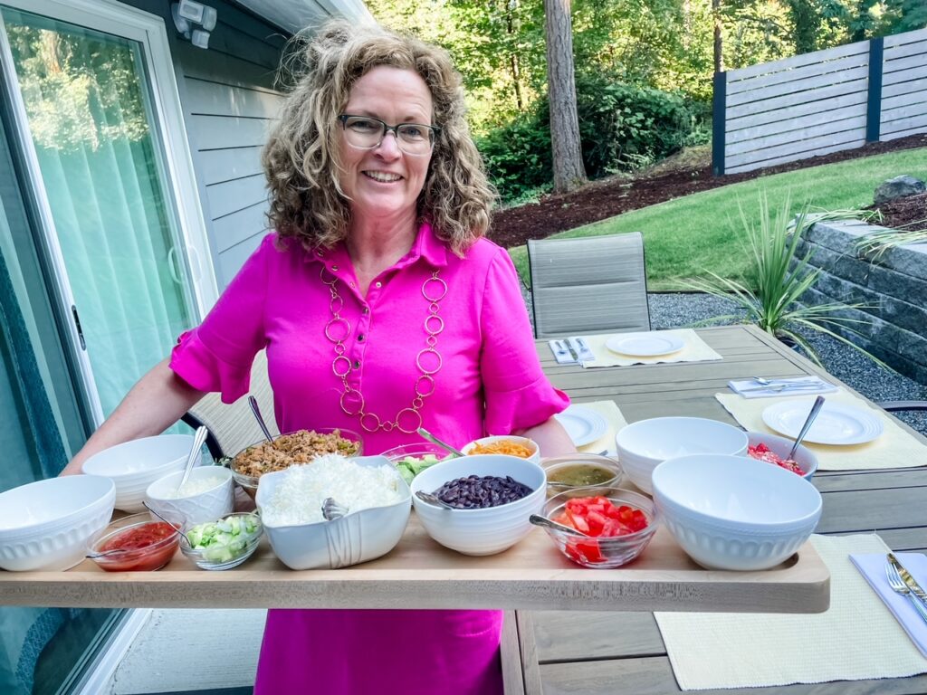 Marie holding her Taco Bowls Board