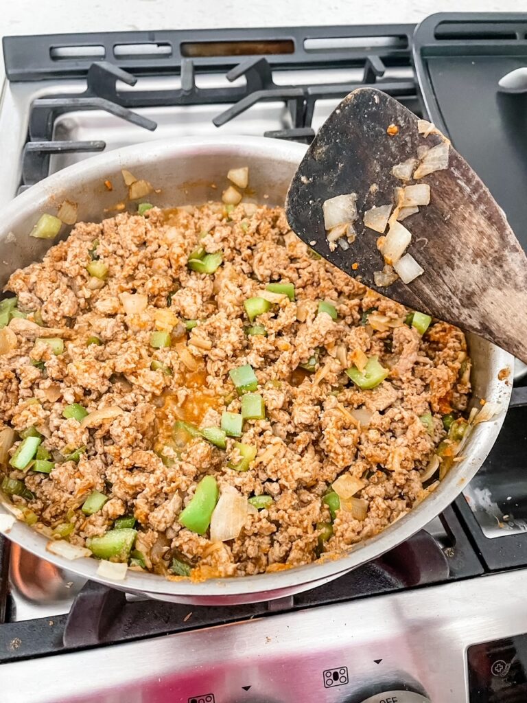 Turkey meat being browned in a skillet