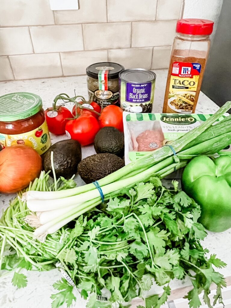 The ingredients for the Taco Bowls Board on a countertop