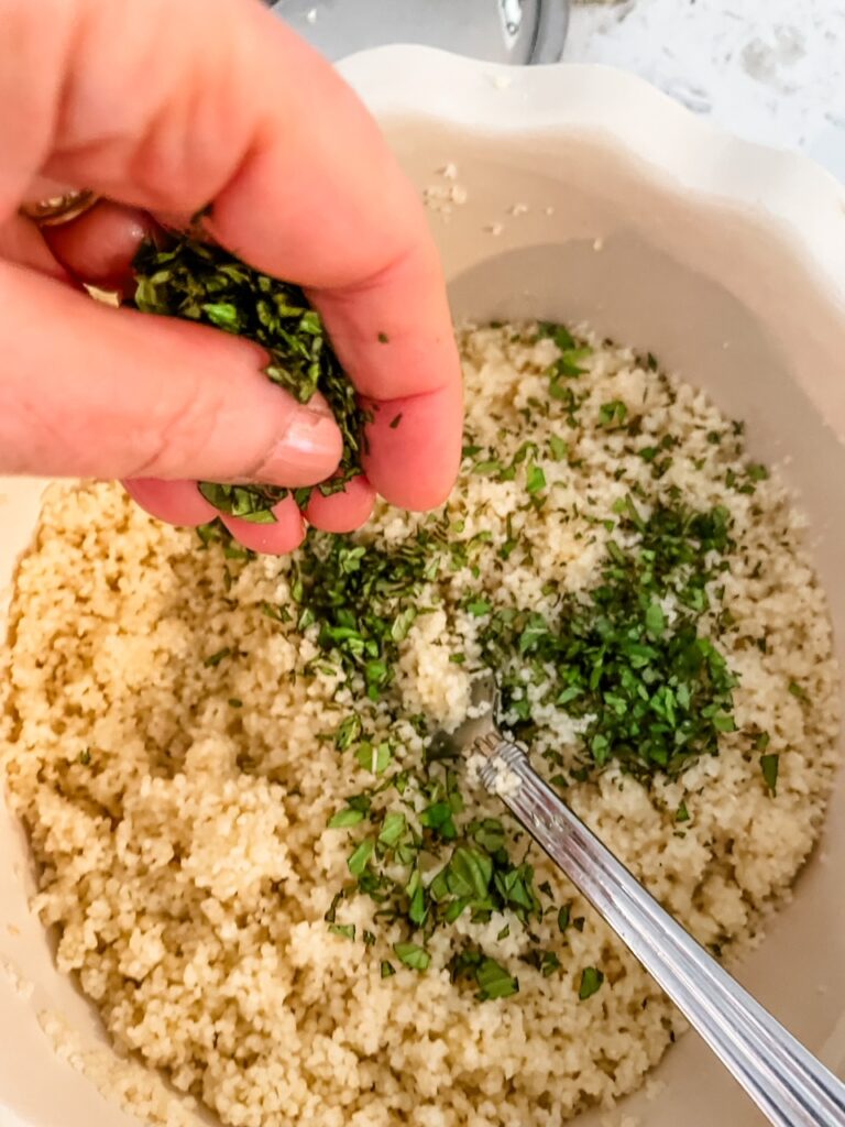 Adding in fresh chopped mint to the couscous