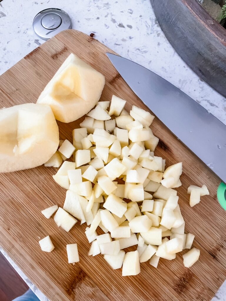 Two apple halves next to cubed apple pieces