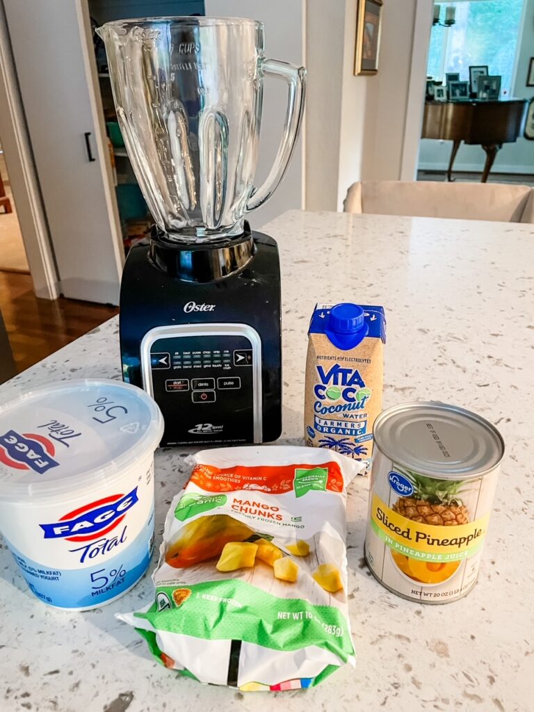 The ingredients for the smoothie on a counter next to the blender