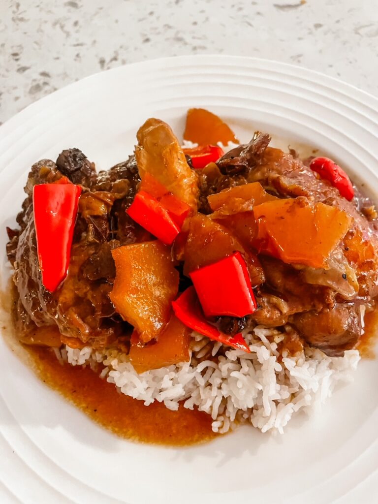 The finished Slow Cooker Huli Huli Chicken served atop of rice