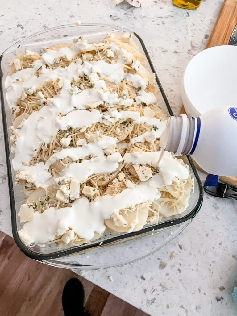 The cream being added to the baking dish