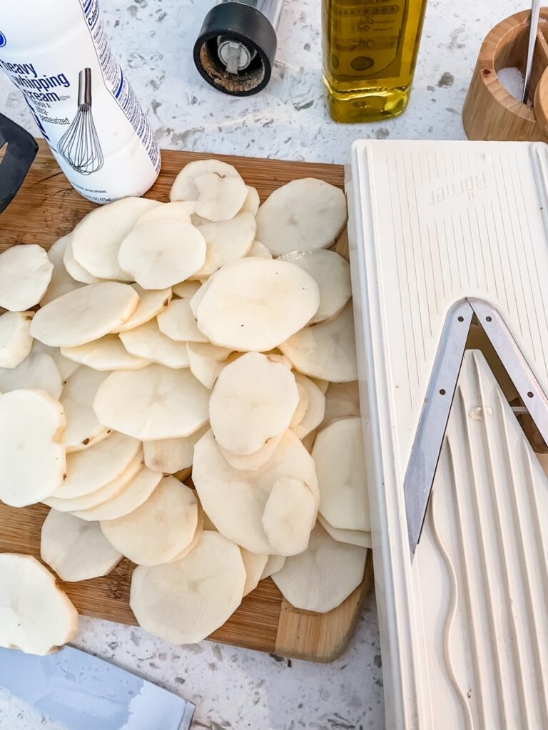 The v slicer being used to thinly slice potatoes