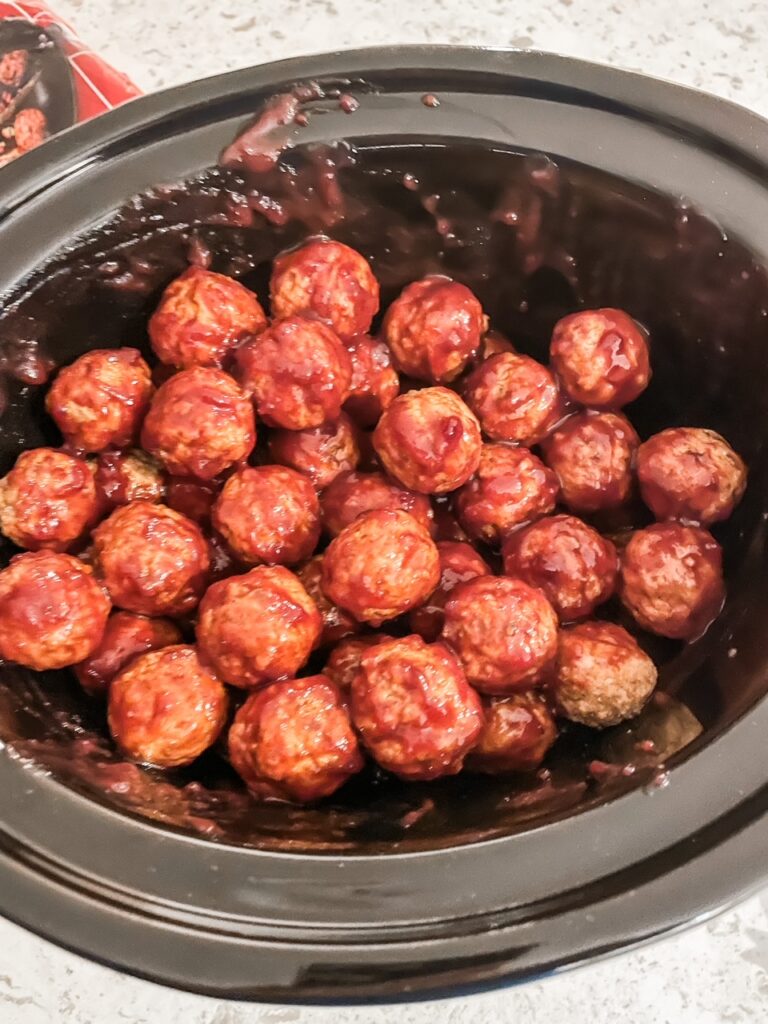 The Easy Cranberry Mustard Slow Cooker Meatballs prepped in a slow cooker