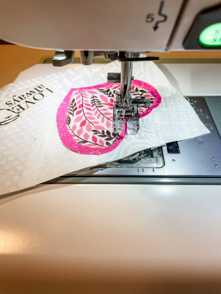 Sewing the heart pieces onto the fabric card