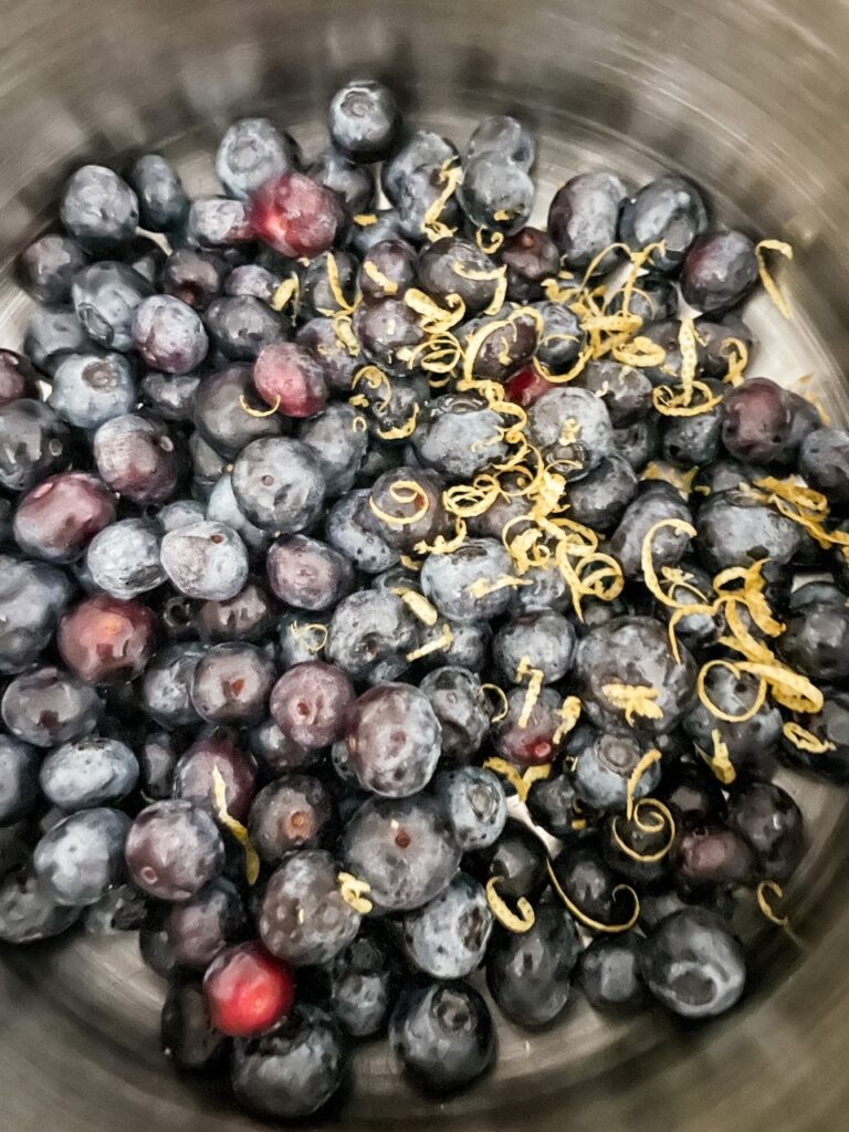 The blueberries and zest in the heavy bottomed pan