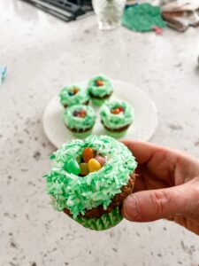 Marie holding up one of the Easter decorated cupcakes