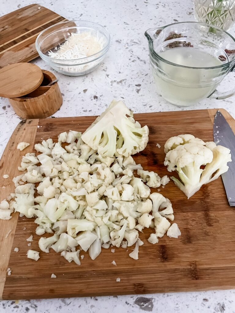 The chopped up cauliflower on a cutting board