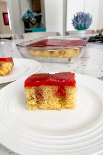 The slice of Strawberry Rhubarb Poke Cake