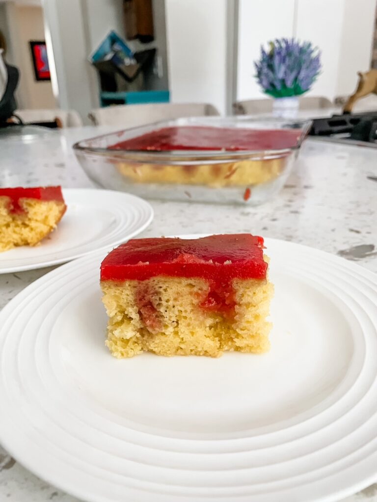 The slice of Strawberry Rhubarb Poke Cake