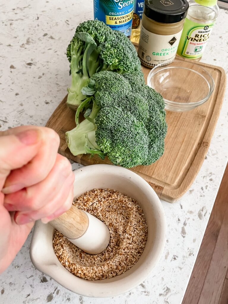 Grinding the sesame seeds in a mortar and pestle