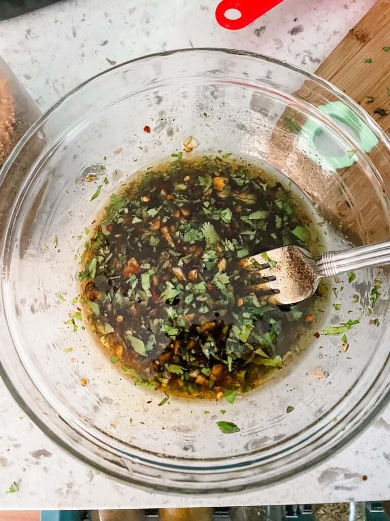 The mixed up marinade in a clear bowl
