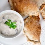 The finished Easy Chicken Curry Hand Pies alongside some dipping sauce