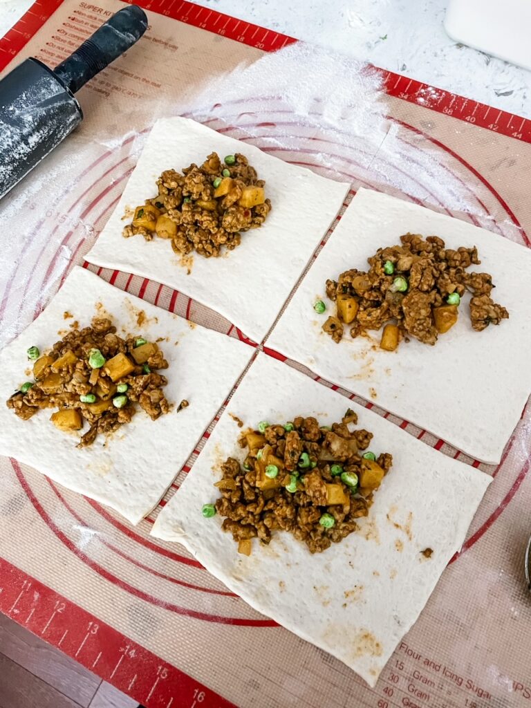 The finished chicken and curry filling on the rolled out pastry