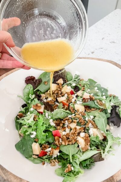 The finished Fall Apple and Gorgonzola Salad having dressing poured over it