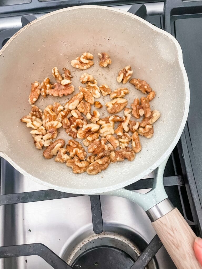 Toasting the walnuts over the stove top