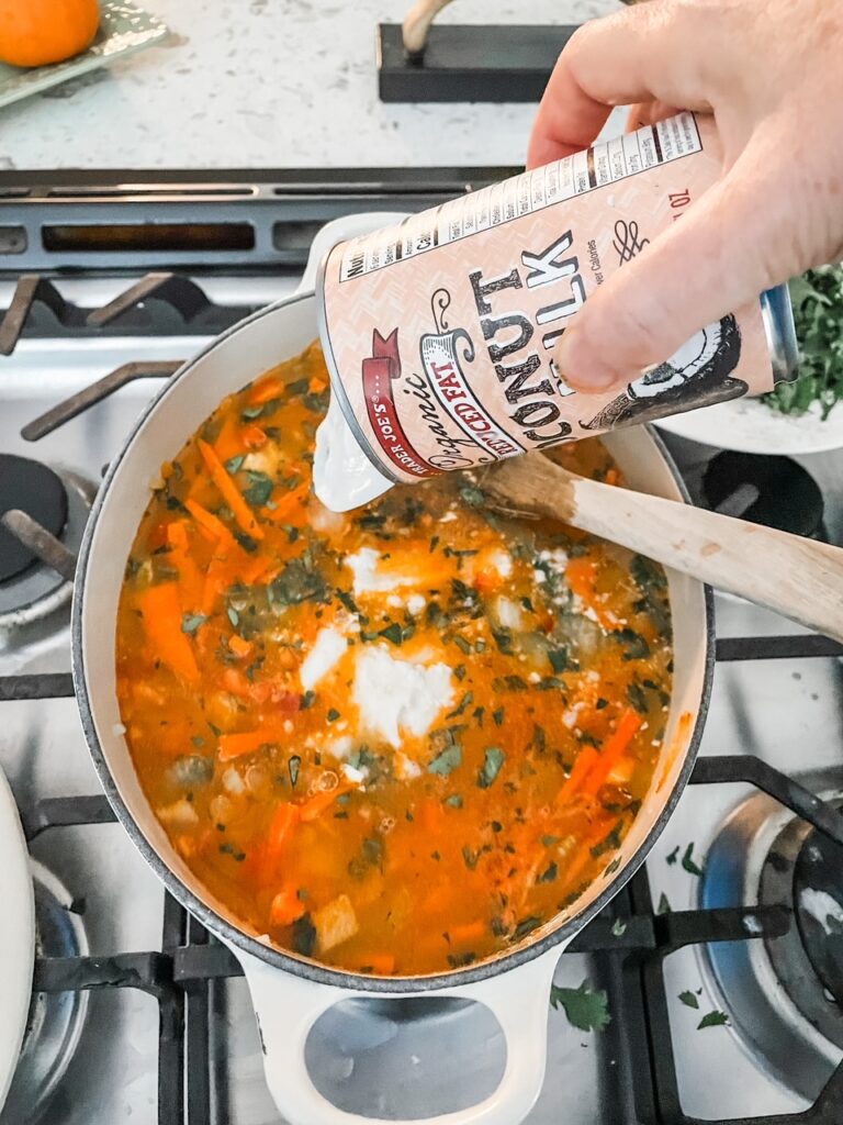 Pouring in low-fat coconut milk into the soup