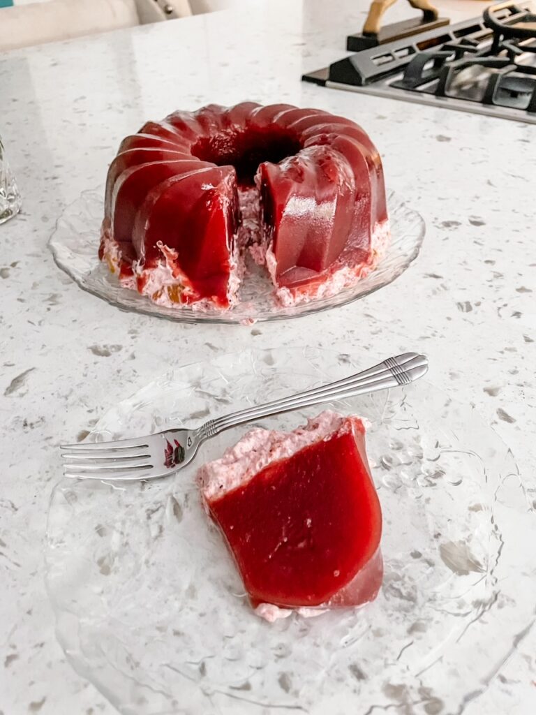 The finished Homemade Holiday Cranberry Gelatin Mold with a slice taken out of it