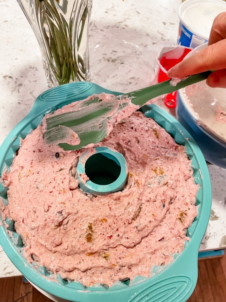 The whipped cream mix spatulaed on top of the mold